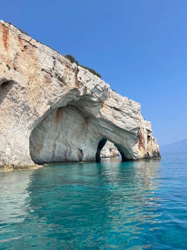 Natural rock arch above turquoise waters at the Blue Caves in Zakynthos